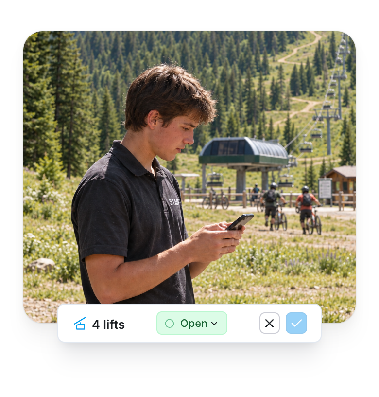 A staff member updates status from a phone. The native bulk toolbar shows four lifts selected and the Open status, ready to confirm.
